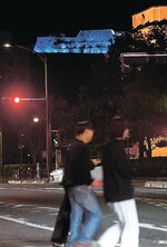インディゴブルーにライトアップされた米子城跡（奥）＝２８日、鳥取県米子市東倉吉町から撮影