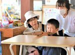 駄菓子が景品の射的に挑戦する子ども（中央）＝４日、鳥取市元大工町の城下町とっとり交流館高砂屋