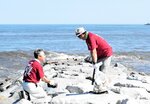岩場に漂着したごみを拾い集める参加者＝１７日、香美町香住区香住のしおかぜ香苑