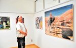 卒業制作の作品（右）など梶木さんが高校時代に描いた油絵を展示している会場＝新温泉町春来の春来地区公民館