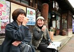 こだわりのコーヒーを片手にレトロな街並みを楽しむ参加者ら＝２３日、倉吉市東仲町の白壁土蔵群周辺
