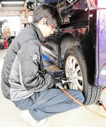 タイヤ交換に追われるスタッフ＝１２日、鳥取市南隈のタイヤ館バイパス店