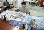 　富山県内の絶景を再現したブランケットを紹介するスズニットの長沢吉将さん