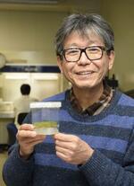 　培養中のヒメツリガネゴケを持つ藤田知道・北海道大教授