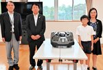 贈呈された芝刈り機を囲む太田校長（左）ら