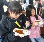 田植えを終えてカレーライスを味わう子どもら
