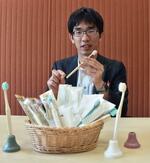　コメを原料に利用した歯ブラシ「ライスクリーン」について紹介する武内和治さん＝２０２５年４月、愛媛県伊予市
