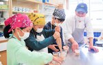 松岡さん（右奥）からポイントなどを教わりながらお菓子作りに挑戦する参加者＝１１日、香美町村岡区入江の射添地区公民館