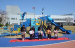 大型複合遊具の前でテープカットをして完成を祝う関係者と園児たち＝３１日、境港市上道町の境中央公園