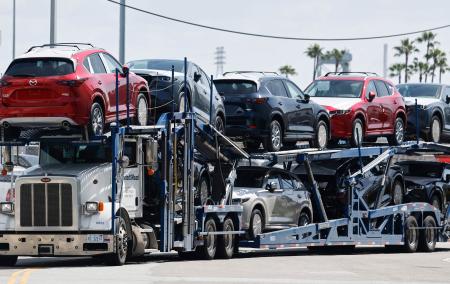 　米ロサンゼルス港で自動車を運ぶ運搬業者＝３日（ゲッティ＝共同）