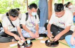 丁寧に茶せんを動かし茶をたてる台湾の生徒たち＝新温泉町諸寄の東藤田邸