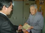 自費出版した本を寄託する藤岡さん（右）＝２００９年11月、倉吉市
